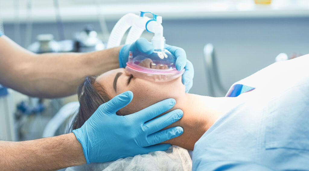 Several doctors surrounding patient on operation table during t -